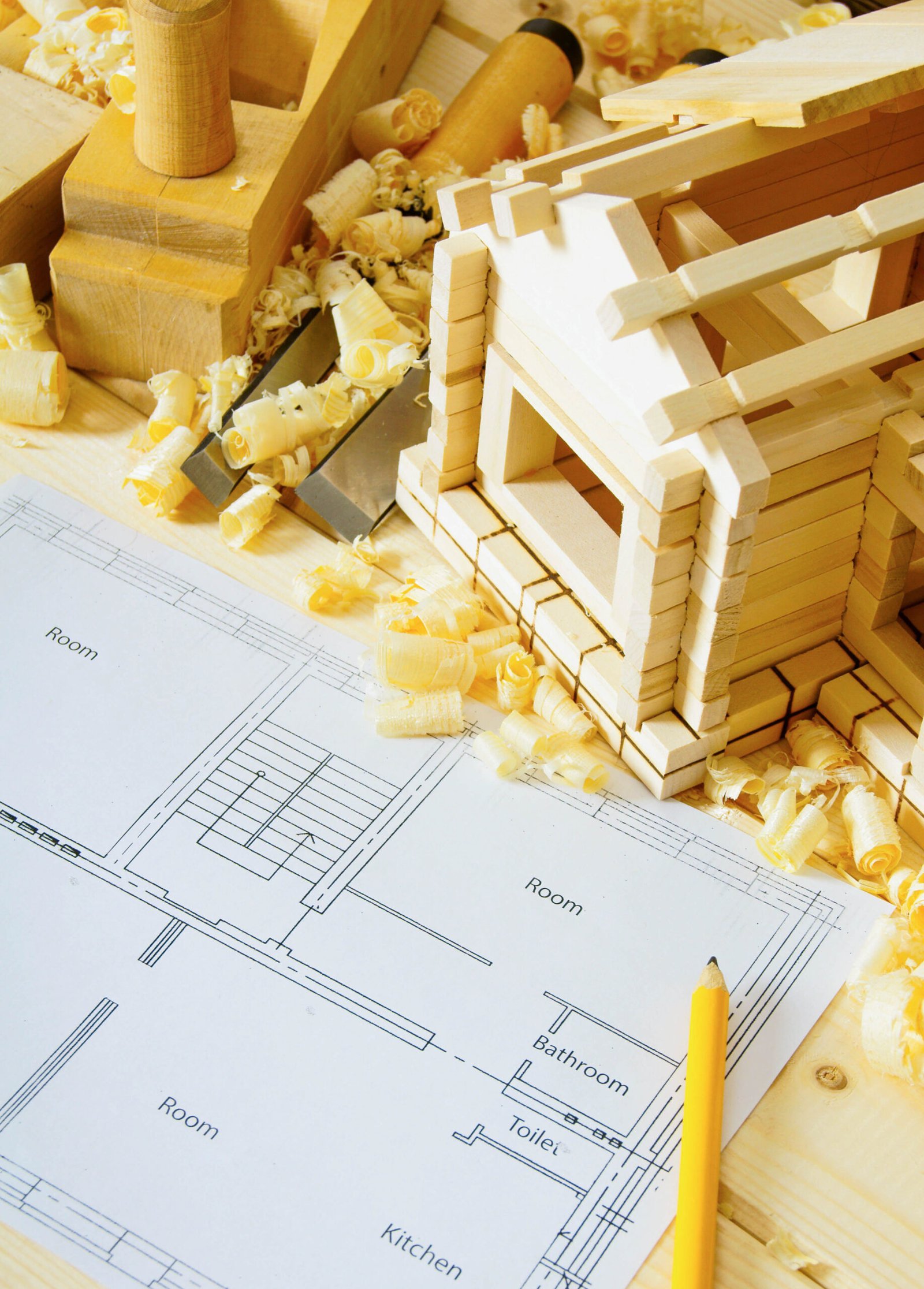 Joiner's works. drawings for building, small house and working tools on wooden background.